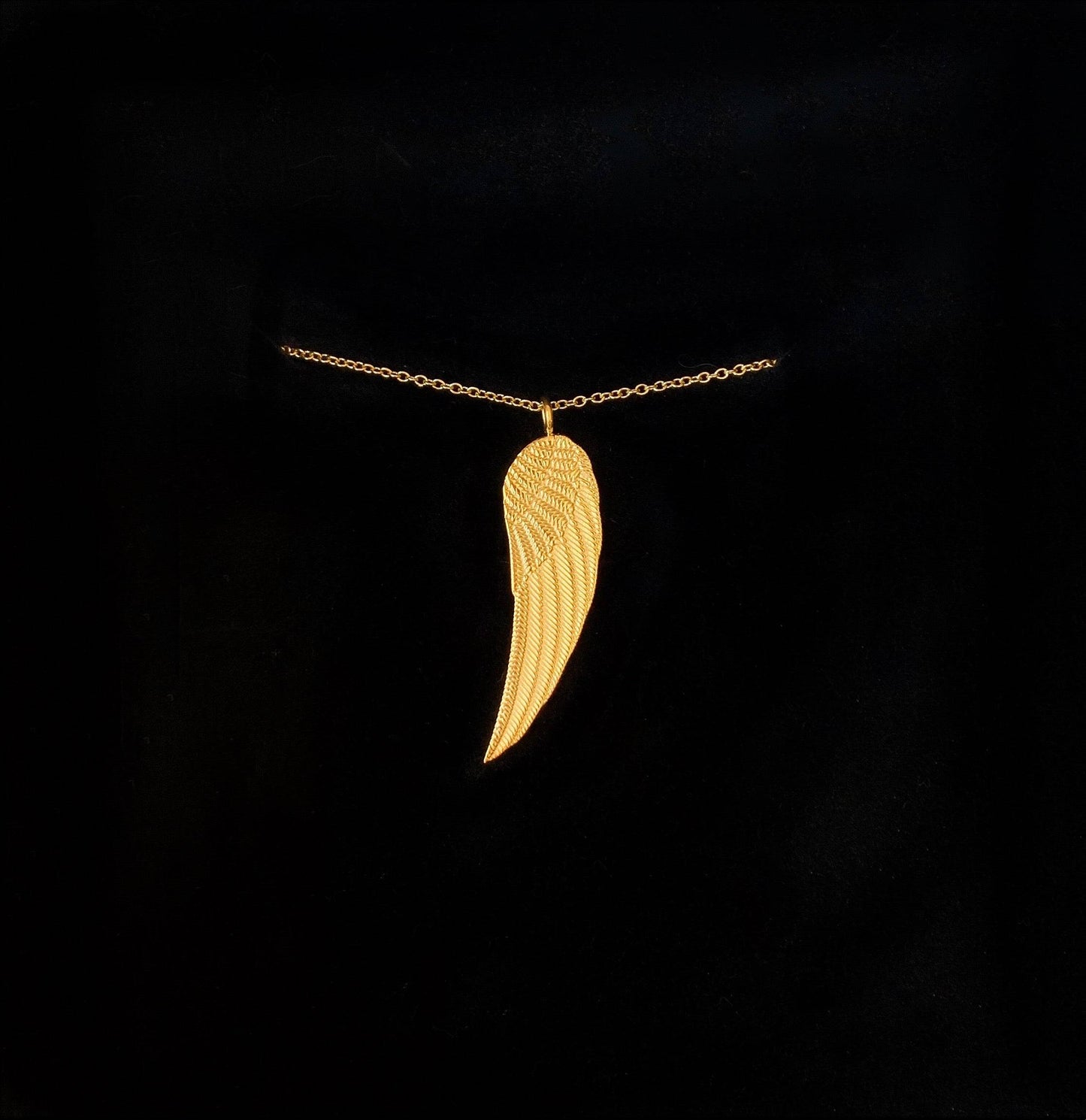 Classy gold-plated chain necklace with wing pendant - in black background